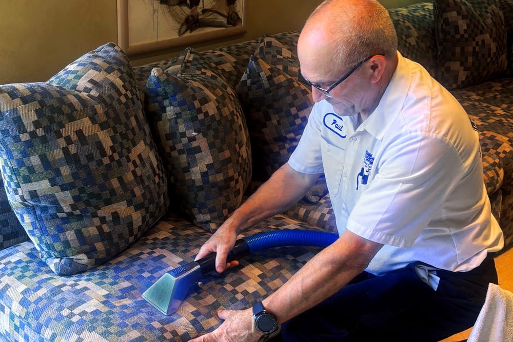 Burrous Brothers Company technician cleaning an upholstered sofa in a Marin County home